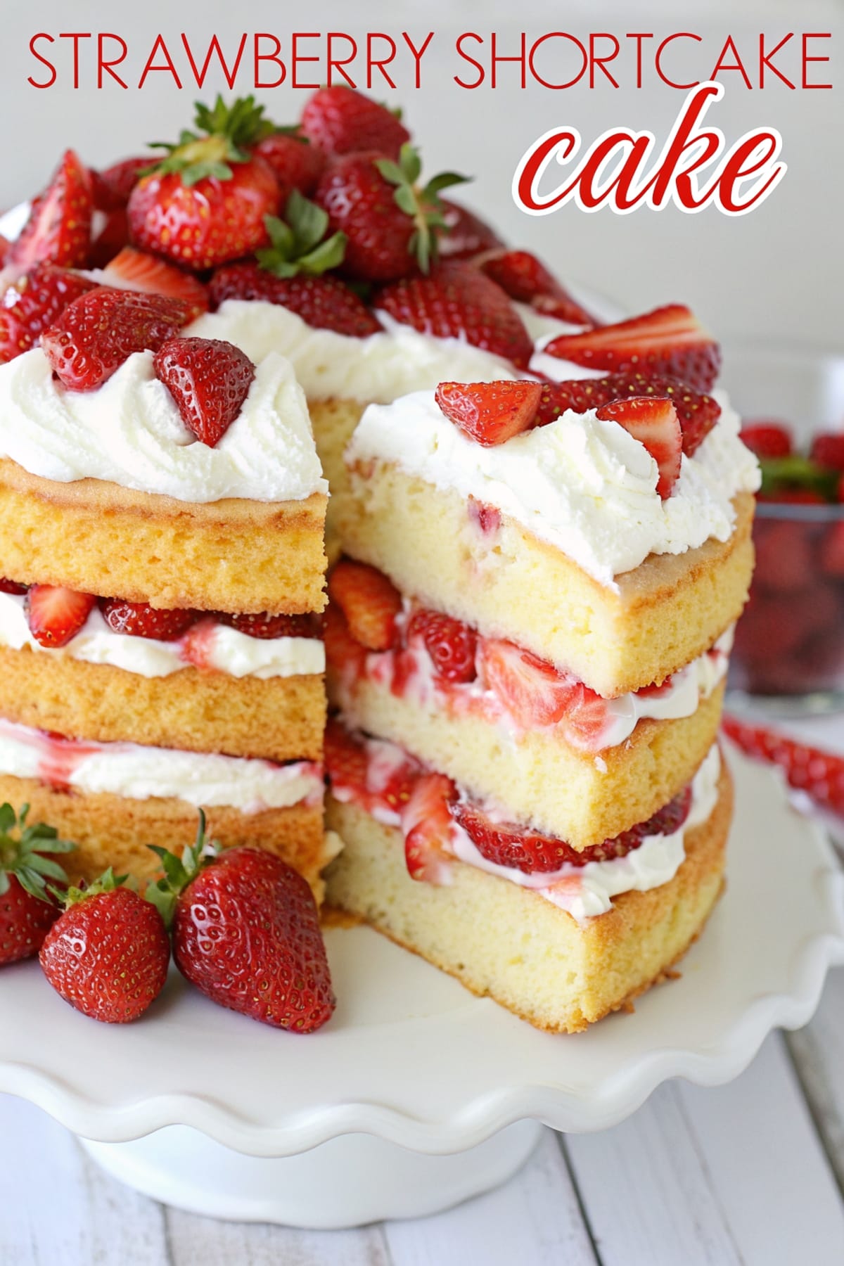 The Best Strawberry Shortcake Cake (Classic, Light & Bakery-Style) 1 strawberry shortcake cake recipe on white cake stand with text overlay 2